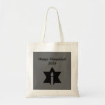 The Flame & Star - Tote Bag<br><div class="desc">This image is a flame from a candle. A star around the flame represents Hanukkah. Done in a black tattoo. A black backround was also added. "Happy Hanukkah 2014" is printed on this design. Customize with your own words. These totes are available in assorted styles,  colors and sizes.</div>