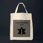 The Flame & Star - Tote Bag<br><div class="desc">This image is a flame from a candle. A star around the flame represents Hanukkah. Done in a black tattoo. A black backround was also added. "Happy Hanukkah 2014" is printed on this design. Customize with your own words. These totes are available in assorted styles, colors and sizes.</div>