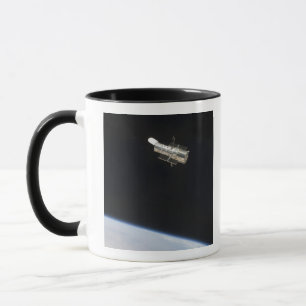 The Hubble Space Telescope in orbit above Earth 2 Mug
