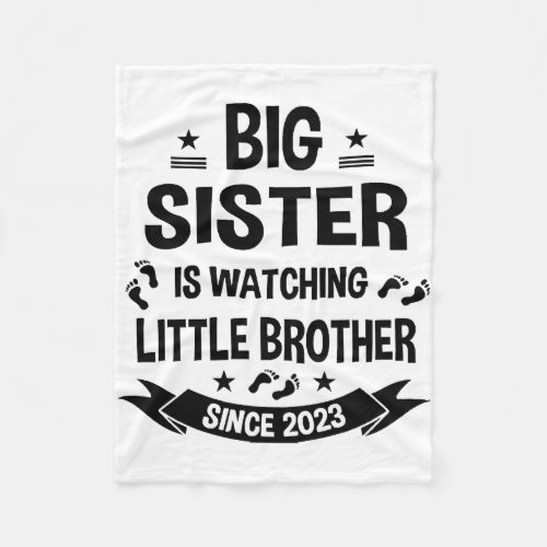 The little sister takes care of the big brother in fleece blanket