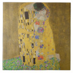 The Lovers Kissing Embrace by Gustav Klimt Ceramic Tile<br><div class="desc">Sunlight glints off the swirling golden embrace that surrounds the lovers in Gustav Klimt's masterpiece, The Kiss. The scene is a paradox of intimacy and isolation. The couple stands on a precipice, a field of colorful flowers at their feet, yet they are oblivious to the world around them. Their gazes...</div>