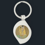 The Lovers Kissing Embrace by Gustav Klimt Keychain<br><div class="desc">Sunlight glints off the swirling golden embrace that surrounds the lovers in Gustav Klimt's masterpiece, The Kiss. The scene is a paradox of intimacy and isolation. The couple stands on a precipice, a field of colorful flowers at their feet, yet they are oblivious to the world around them. Their gazes...</div>