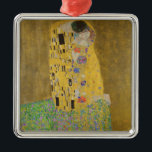 The Lovers Kissing Embrace by Gustav Klimt Metal Ornament<br><div class="desc">Sunlight glints off the swirling golden embrace that surrounds the lovers in Gustav Klimt's masterpiece, The Kiss. The scene is a paradox of intimacy and isolation. The couple stands on a precipice, a field of colorful flowers at their feet, yet they are oblivious to the world around them. Their gazes...</div>