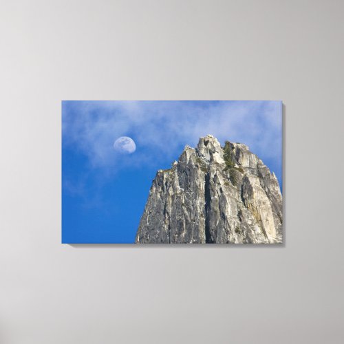 The moon rises and shines through the clouds canvas print