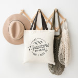 The Mountains Are Calling Tote Bag<br><div class="desc">Indulge your spirit of adventure with our wanderlust-inspiring tote bag,  featuring the quote "the mountains are calling and I must go" in rugged outdoorsy typography with a mountain range illustration.</div>