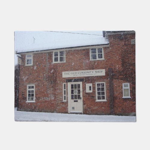 the old curiosity shop in snow english christmas doormat