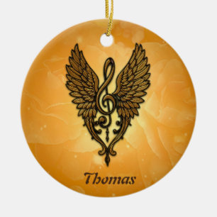 The soul of the melody, a golden clef with wings. ceramic ornament