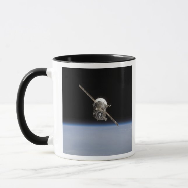The Soyuz TMA-11 spacecraft above Earth's horiz Mug (Left)