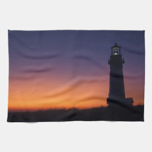 The sun ball drops down on the colorful horizon towel