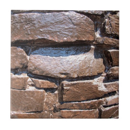 The wall of the large natural stone painted brown ceramic tile