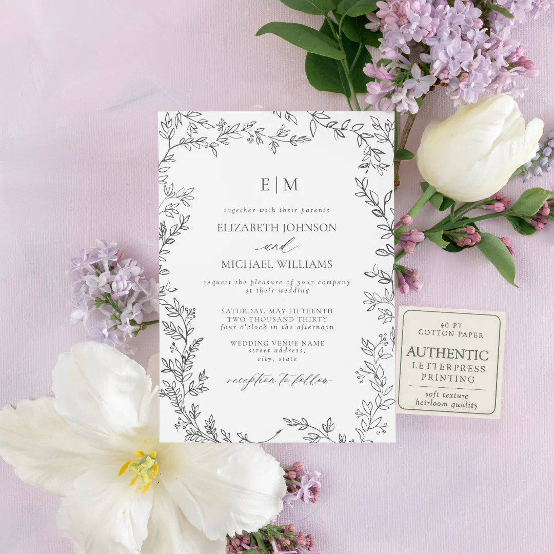 The invitation design illustrates a foliage/leaf border with plain and scripted text. In the background there's flowers and an overall purple aesthetic.