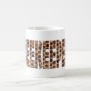 The word beekeeper with an overlay of honeycomb. coffee mug