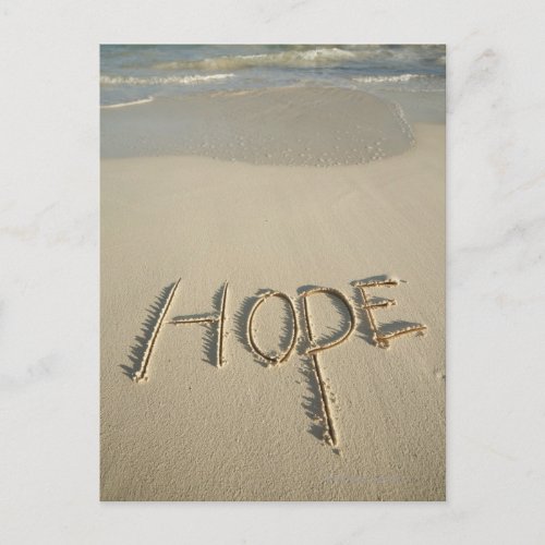 The word Hope sand written on the beach with Postcard