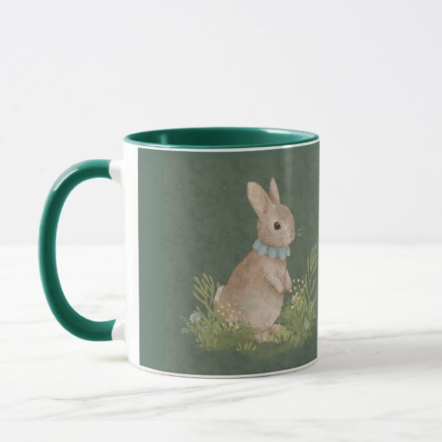 There's a rabbit with a decoration on its neck sit mug (Left)