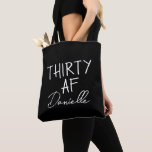 THIRTY AF Personalized Funny 30th Birthday Tote Bag<br><div class="desc">This personalized “THIRTY AF” tote bag is the ultimate 30th birthday accessory — bold, fun, and fabulously functional. Featuring a custom name in elegant script beneath the playful slogan, it’s perfect for brunches, gifting, errands, or that post-party coffee run. Made for birthdays with attitude, this bag is as stylish as...</div>