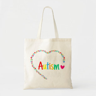 This colorful autism heart made with puzzle pieces tote bag