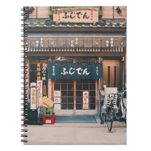 THREE BICYCLES PARKED IN FRONT OF BUILDING NOTEBOOK (Front)