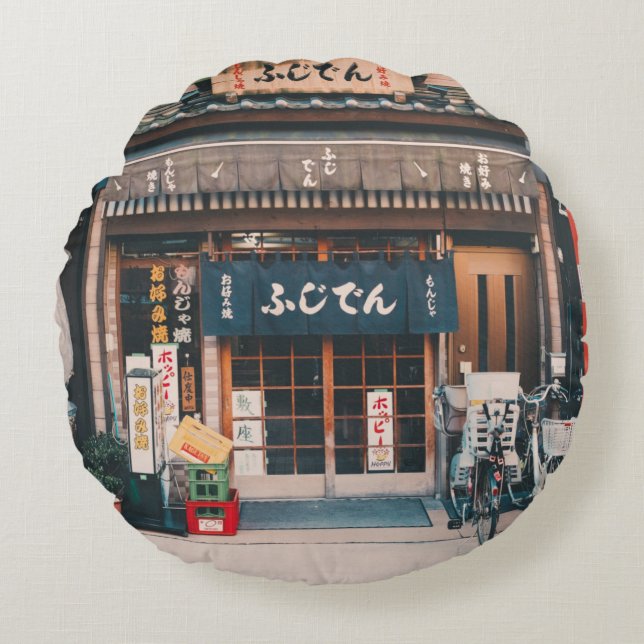 THREE BICYCLES PARKED IN FRONT OF BUILDING ROUND PILLOW (Front)