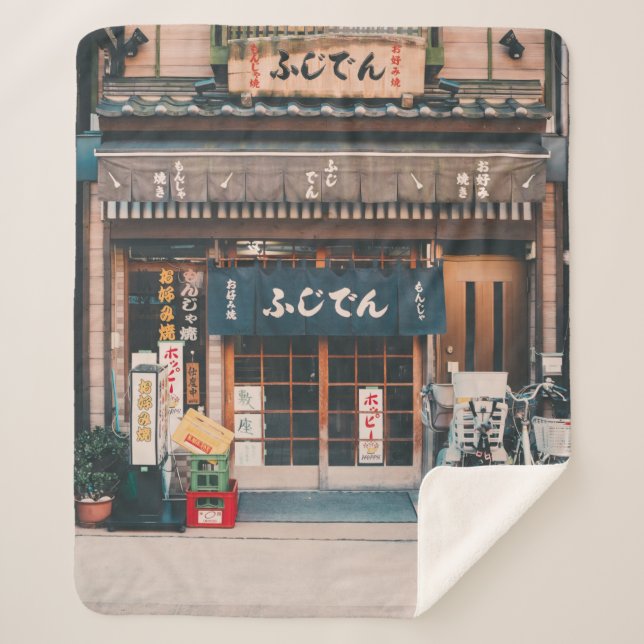 THREE BICYCLES PARKED IN FRONT OF BUILDING SHERPA BLANKET (Front)