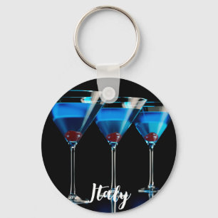 Three blue cocktails with cherry on black keychain