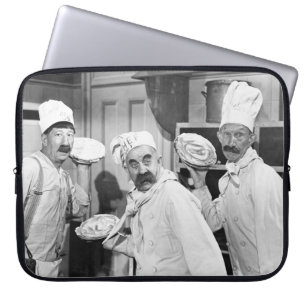 Three chefs holding pies for a fight in the kitche laptop sleeve