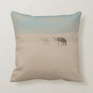 Three dromedary camels walking in Sahara desert Throw Pillow