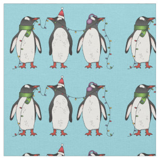 Three Festive Christmas Penguins On Light Blue Fabric