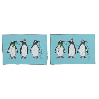 Three Festive Christmas Penguins On Light Blue Pillow Case