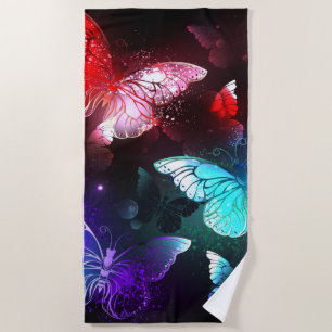 Three Glowing Butterflies on night background Beach Towel