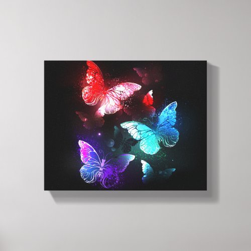 Three Glowing Butterflies on night background Canvas Print