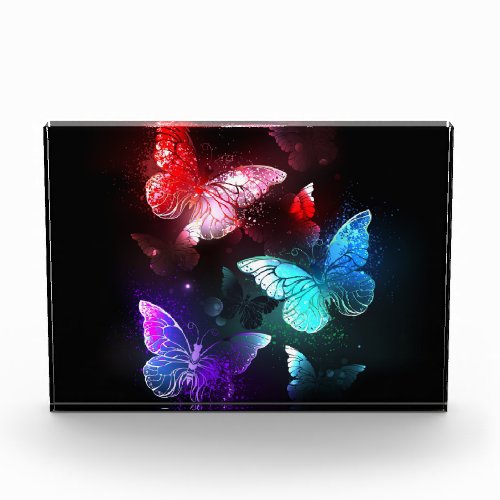 Three Glowing Butterflies on night background Photo Block