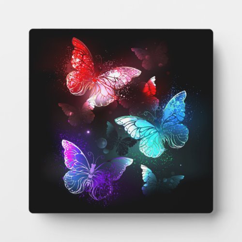Three Glowing Butterflies on night background Plaque