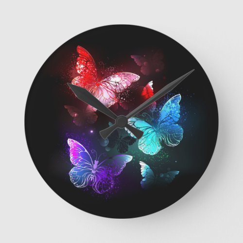 Three Glowing Butterflies on night background Round Clock