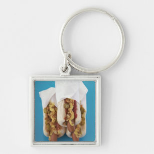 Three hot dogs in buns keychain