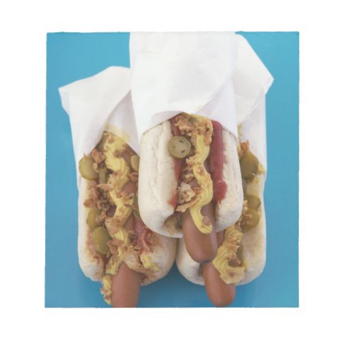 Three hot dogs in buns notepad
