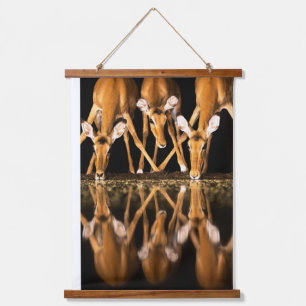 Three Impala Drink Together at Night Hanging Tapestry