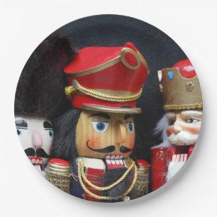 Three nutcrackers on dark background paper plates