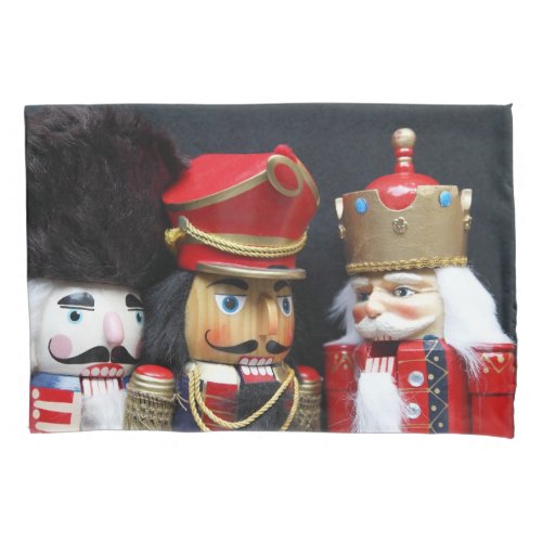 Three nutcrackers on dark background pillow case