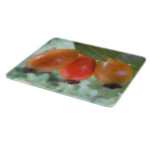 Three orange rosehips cutting board