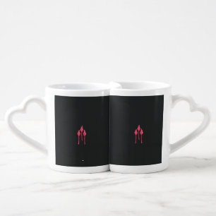 Three pink flowers with a black background coffee mug set
