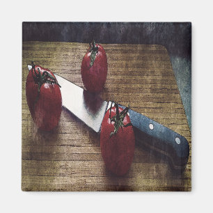 Three red tomatoes on a chopping board magnet