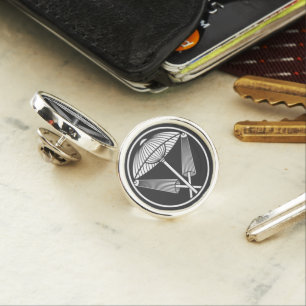 Three umbrellas in a threadlike ring lapel pin