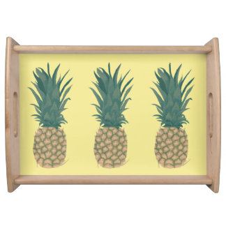 Three Whole Pineapples on Yellow Serving Trays