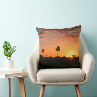 Throw Pillow with a flock of birds on sunset