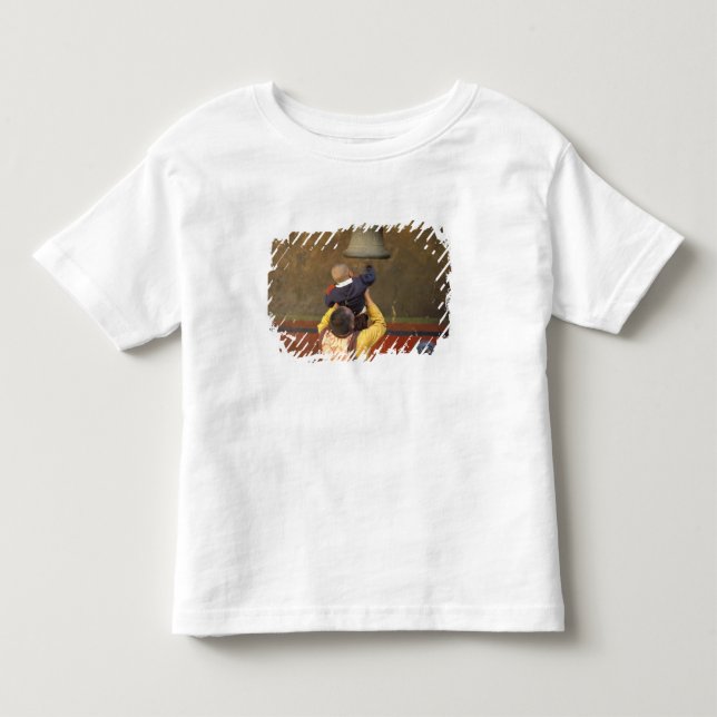 Tibetan Buddhist monk lifting a boy to ring a Toddler T-shirt (Front)