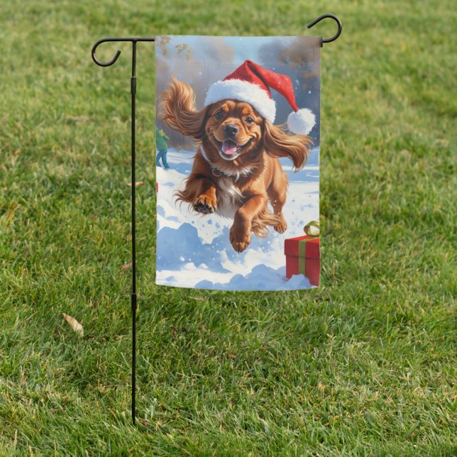 Tibetan Spaniel Running in Snow with Christmas Hat Garden Flag (In SItu)