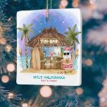 Tiki Beach Bar Moonlight Santa Tropical Christmas Ceramic Ornament<br><div class="desc">Tropical Christmas ornament features Santa enjoying a vacation at a Tiki bar on the beach under the moon and stars with palm trees, string lights and Hawaiian "Aloha" and "Mele Kalikimaka" greetings. Tropical cocktails, a pineapple, hibiscus and palm leaves, a surfboard and a parrot in a pirate hat decorate the...</div>