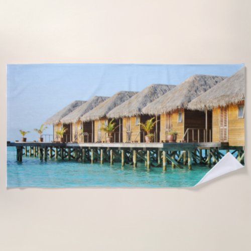 Tiki Huts on a Pier with Thatched Roofs Beach Towel