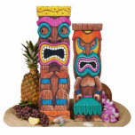 Tiki Totems Sculpture<br><div class="desc">5” x 7” acrylic photo sculpture of two colorful wooden tiki totems,  an orchid lei,  a pineapple,  a bunch of grapes,  a lemon slice and assorted seashells. See the entire Shipwreck Photo Sculpture collection in the DECOR | Props & Centerpieces section.</div>