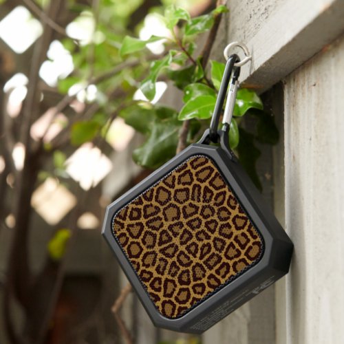 Tile background with a leopard fur bluetooth speaker